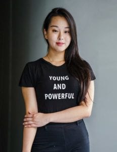 Young woman with tshirt reading "young and powerful"